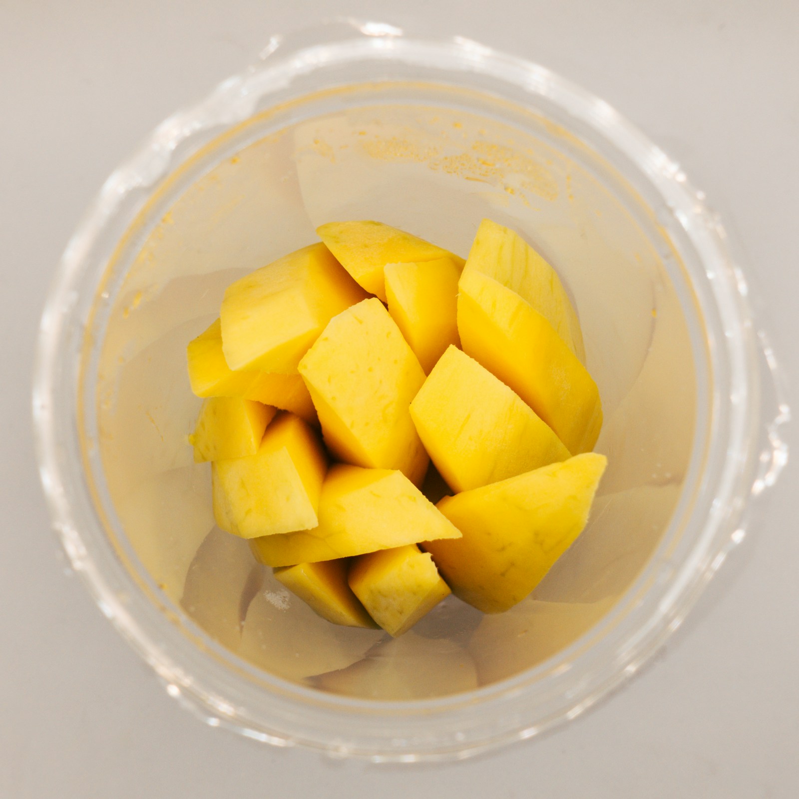 Bowl of diced mango pieces ready for freezing