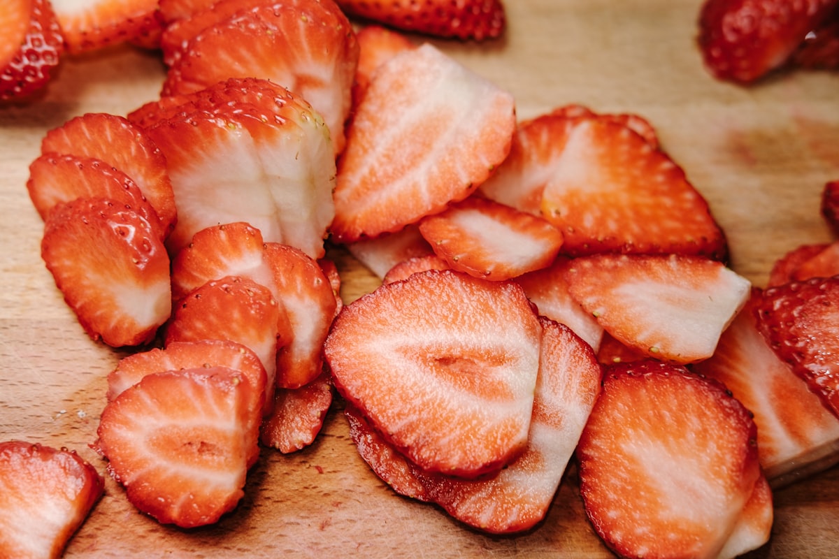 Frozen strawberry halves with frost crystals